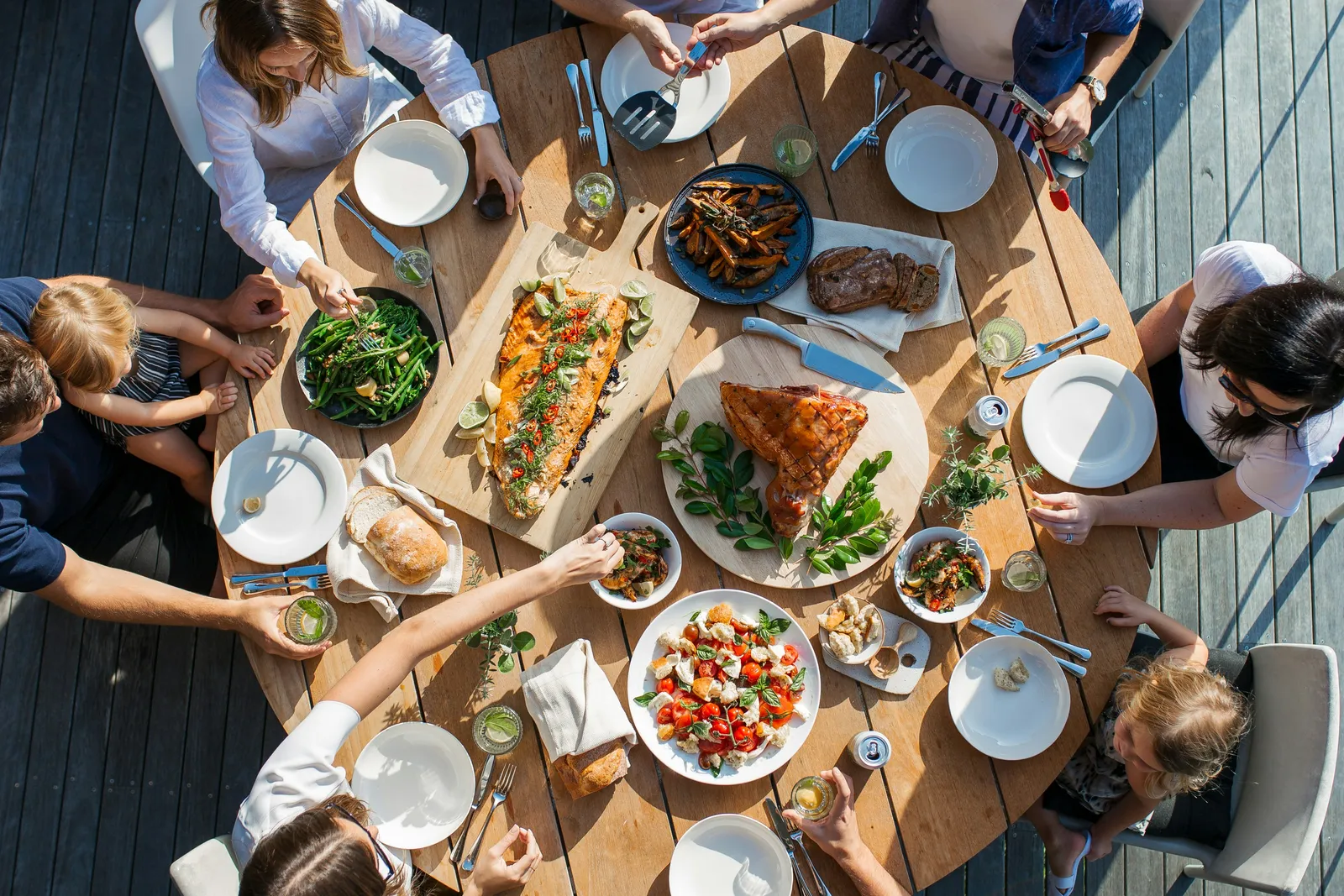 A full table of guests sharing dishes, seen from above