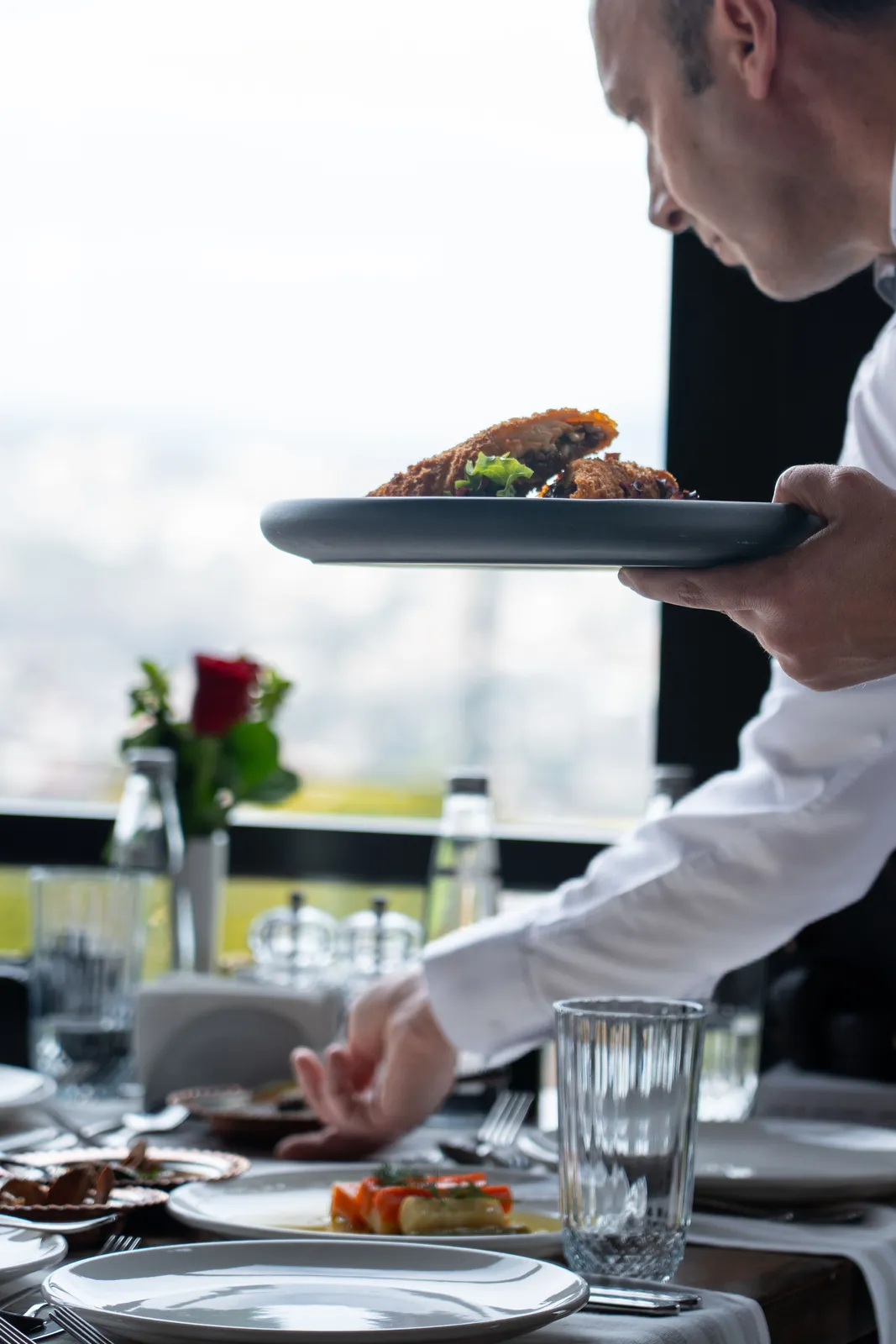 A full table of guests sharing dishes, seen from above